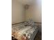 The bedroom features a twin-sized bed with decorative pillows and a headboard with a floral bedspread at 7950 Eagle Valley Pass, Indianapolis, IN 46214