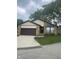 Charming home featuring a stone facade, attached garage, and well-manicured lawn at 7950 Eagle Valley Pass, Indianapolis, IN 46214