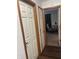 A hallway reveals an office space with neutral walls and a comfortable chair at 7950 Eagle Valley Pass, Indianapolis, IN 46214