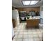 Bright kitchen with oak cabinets, center island, and light tile flooring at 7950 Eagle Valley Pass, Indianapolis, IN 46214