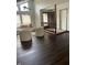 Bright living room featuring large windows, modern furniture, and dark wood flooring at 7950 Eagle Valley Pass, Indianapolis, IN 46214