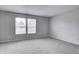 Light-filled bedroom with carpet, large windows, and neutral paint creates a serene and inviting atmosphere at 8030 Cork Bend Ln, Indianapolis, IN 46239