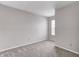 Bedroom features neutral carpet, walls, and trim, window view, and electrical outlets at 8030 Cork Bend Ln, Indianapolis, IN 46239
