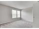 This bedroom features neutral walls, plush carpeting, and bright natural light from two windows at 8030 Cork Bend Ln, Indianapolis, IN 46239