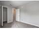 Bedroom featuring neutral carpet, closet, white trim, and a closed white door at 8030 Cork Bend Ln, Indianapolis, IN 46239