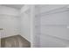 Walk-in closet featuring wire shelving and carpeted flooring for organized storage at 8030 Cork Bend Ln, Indianapolis, IN 46239