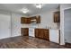 Well-equipped kitchen features ample cabinetry, white appliances, and wood-look flooring, perfect for cooking at 8030 Cork Bend Ln, Indianapolis, IN 46239