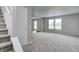 Bright living room with neutral paint, plush carpeting, and large windows providing ample natural light at 8030 Cork Bend Ln, Indianapolis, IN 46239
