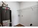 Utility room featuring a water heater and shelving for storage at 8030 Cork Bend Ln, Indianapolis, IN 46239