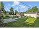 Spacious backyard showcasing lush green grass, and a detached garage at 808 N Layman Ave, Indianapolis, IN 46219