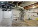 Unfinished basement with a concrete floor and exposed duct work at 808 N Layman Ave, Indianapolis, IN 46219