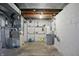 Unfinished basement with a concrete floor and water heater at 808 N Layman Ave, Indianapolis, IN 46219