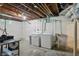 Unfinished basement with washer, dryer, and wash basin at 808 N Layman Ave, Indianapolis, IN 46219