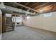 Partially finished basement with painted walls and exposed ceiling joists at 808 N Layman Ave, Indianapolis, IN 46219