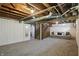 Spacious unfinished basement area with carpeting and access to stairs at 808 N Layman Ave, Indianapolis, IN 46219