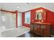 Bright bathroom featuring a walk-in shower, dark vanity, and a large mirror at 808 N Layman Ave, Indianapolis, IN 46219