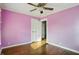 Bedroom featuring natural lighting, ceiling fan, hardwood floors, and a closet door at 808 N Layman Ave, Indianapolis, IN 46219