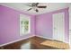 Sun-lit bedroom featuring hardwood floors and a ceiling fan at 808 N Layman Ave, Indianapolis, IN 46219