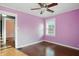 Cozy bedroom with hardwood floors and natural light shining through the window at 808 N Layman Ave, Indianapolis, IN 46219