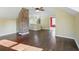 Bonus room with hardwood floors, exposed brick column, and bright lighting at 808 N Layman Ave, Indianapolis, IN 46219