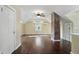 Spacious bonus room featuring hardwood floors, natural light, and an exposed brick column at 808 N Layman Ave, Indianapolis, IN 46219