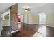 Bright bonus room with hardwood floors, exposed brick column, and bright lighting at 808 N Layman Ave, Indianapolis, IN 46219