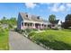 Two-story home with a covered front porch, landscaped yard and private driveway at 808 N Layman Ave, Indianapolis, IN 46219