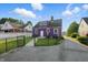 Unique two-story home with fresh paint, fenced-in yard, and paved driveway at 808 N Layman Ave, Indianapolis, IN 46219