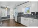 Bright kitchen with stainless steel appliances, white cabinets, and large windows with a traditional ceiling light at 808 N Layman Ave, Indianapolis, IN 46219