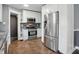 Well-lit kitchen featuring stainless steel appliances, stylish cabinets, and complementary backsplash at 808 N Layman Ave, Indianapolis, IN 46219