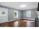 Living room featuring hardwood floors, neutral walls, and natural light from multiple windows at 808 N Layman Ave, Indianapolis, IN 46219