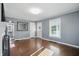 Bright living room with hardwood floors, neutral walls, and a view of the hall bathroom at 808 N Layman Ave, Indianapolis, IN 46219