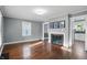 Bright living room featuring hardwood floors and fireplace, complemented by light gray walls at 808 N Layman Ave, Indianapolis, IN 46219