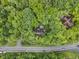 An aerial shot shows the house nestled within a verdant, dense forest at 8310 Fall Creek Rd, Indianapolis, IN 46256