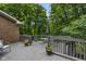 Spacious back deck features a table and chairs and overlooks a wooded backyard at 8310 Fall Creek Rd, Indianapolis, IN 46256