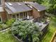 Upper angle of a backyard deck featuring a patio set and lush landscaping at 8310 Fall Creek Rd, Indianapolis, IN 46256