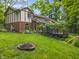 Expansive backyard featuring a fire pit and a wooden deck, perfect for outdoor gatherings and relaxation at 8310 Fall Creek Rd, Indianapolis, IN 46256