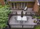 Wooden deck with a dining table, seating, and landscaping surround creating a private outdoor space at 8310 Fall Creek Rd, Indianapolis, IN 46256