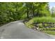 Long private driveway with lush greenery on both sides at 8310 Fall Creek Rd, Indianapolis, IN 46256