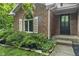 Charming brick home featuring a well maintained lawn and front porch entry at 8310 Fall Creek Rd, Indianapolis, IN 46256