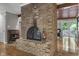 Beautifully crafted brick fireplace with glass door insert is the centerpiece of the living room at 8310 Fall Creek Rd, Indianapolis, IN 46256