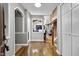 Inviting foyer with hardwood floors and an open view into the spacious living area with a fireplace at 8310 Fall Creek Rd, Indianapolis, IN 46256
