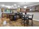 Open kitchen with hardwood floors, granite countertops, stainless steel appliances, and a breakfast bar at 8310 Fall Creek Rd, Indianapolis, IN 46256