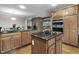 Well-equipped kitchen with stainless steel appliances, black granite countertops, and wooden cabinets at 8310 Fall Creek Rd, Indianapolis, IN 46256