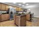 Spacious kitchen features two islands, wooden cabinets, black countertops, and stainless steel appliances at 8310 Fall Creek Rd, Indianapolis, IN 46256