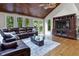 Spacious living room featuring hardwood floors, a vaulted ceiling, and a large sectional sofa at 8310 Fall Creek Rd, Indianapolis, IN 46256