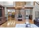 Spacious living room featuring a brick fireplace, hardwood floors, and an open layout perfect for entertaining at 8310 Fall Creek Rd, Indianapolis, IN 46256