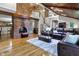 Spacious living room with vaulted wood ceilings, fireplace, skylights, and access to dining room at 8310 Fall Creek Rd, Indianapolis, IN 46256