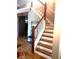Staircase with wooden steps, white railings and neutral colored walls at 8310 Fall Creek Rd, Indianapolis, IN 46256