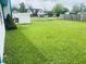 Lush backyard featuring healthy grass, a garden bed, and privacy fencing, perfect for outdoor enjoyment at 8318 Rob Ln, Indianapolis, IN 46237